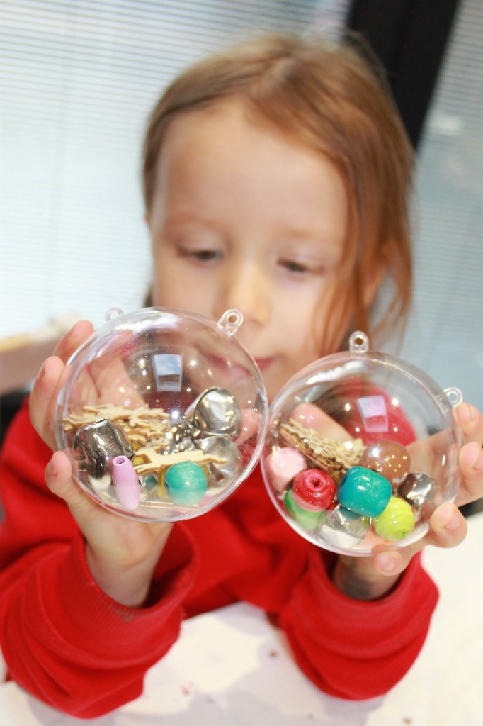 N holding filled baubles