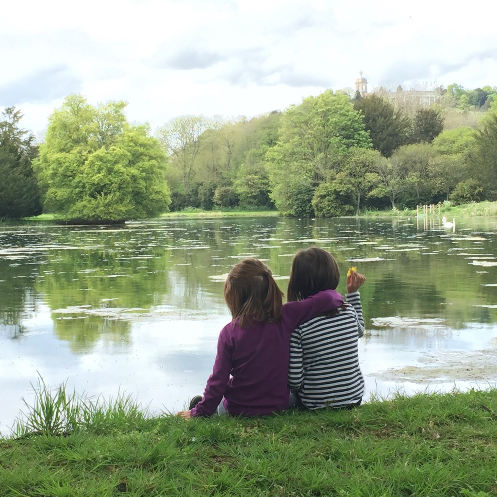 Girls hugging by lake silent sunday