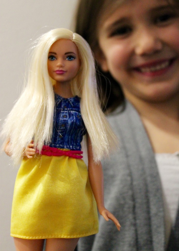 The evolution of barbie - L holding one