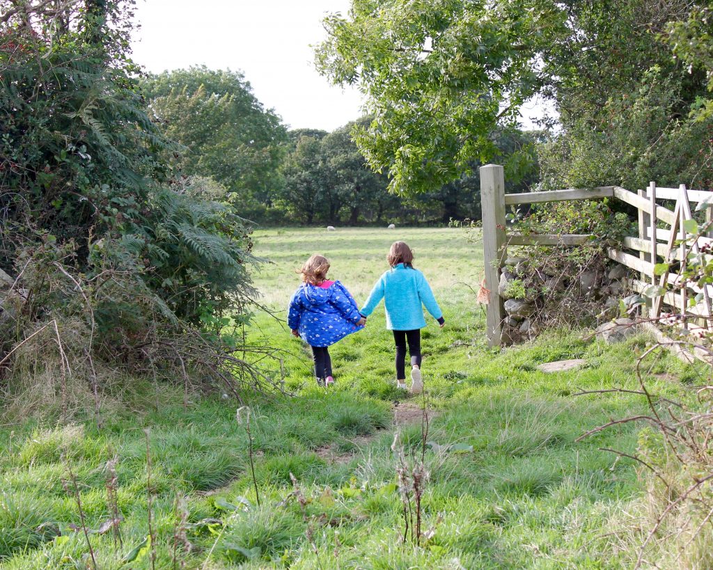 girls walking hand-in-hand lighthouse kids' outdoor clothing 
