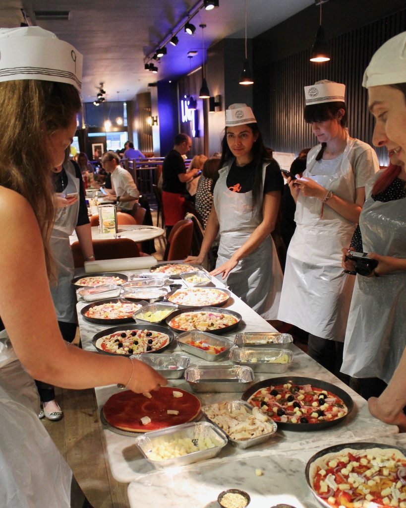 Bloggers making pizzas