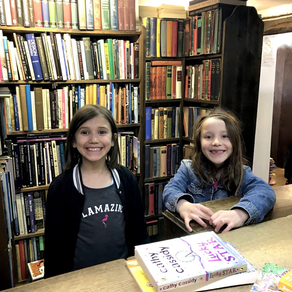 Encouraging children to read - girls at the counter buying books