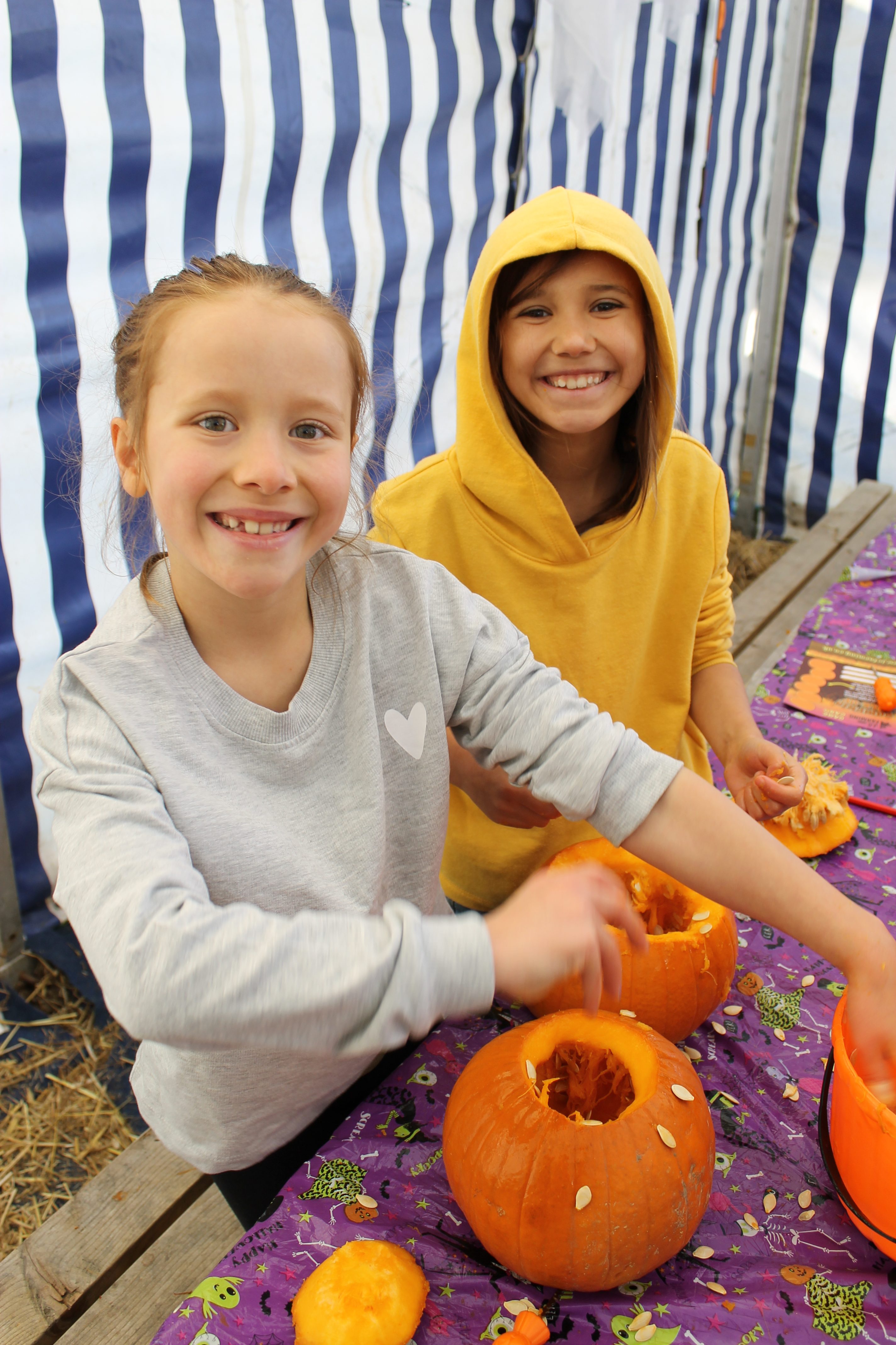 pumpkin carving girls smiling with pumpkin