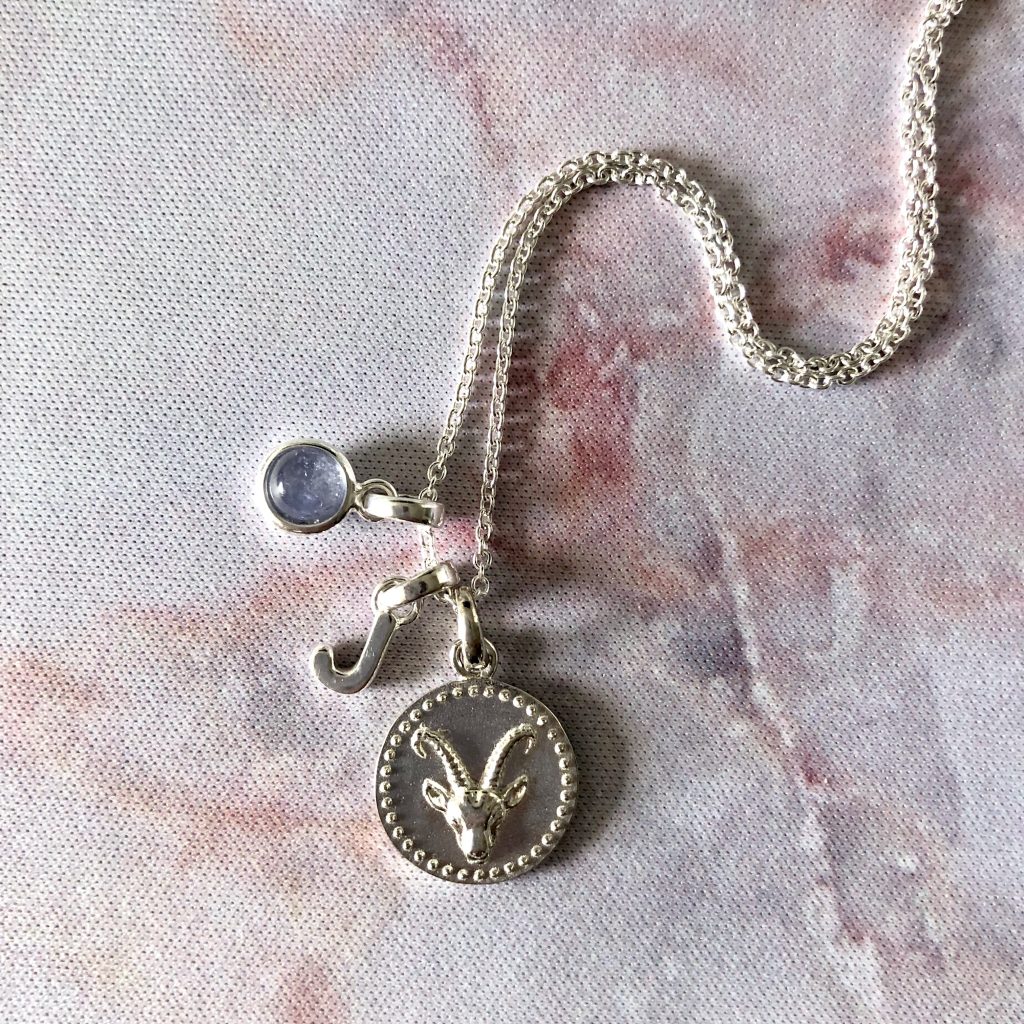 zodiac necklace flatlay