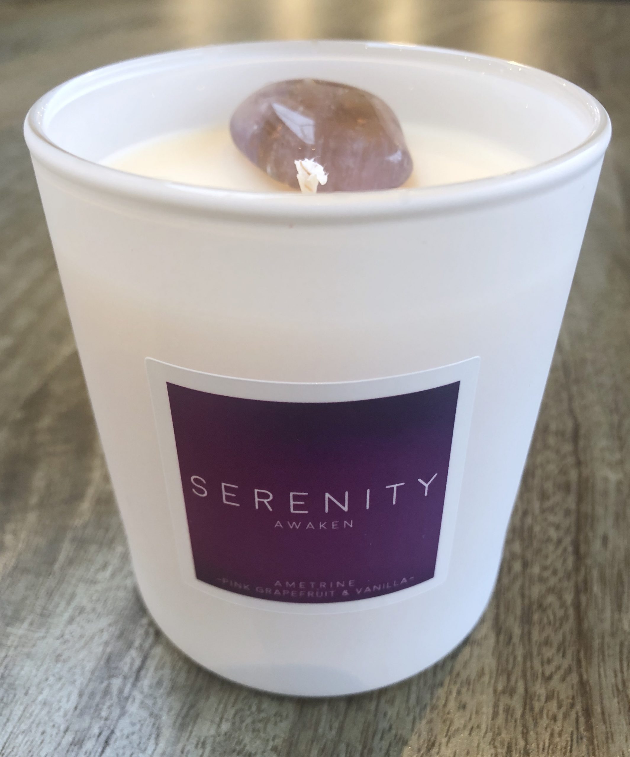 scented candle with a healing crystal close up candle shot