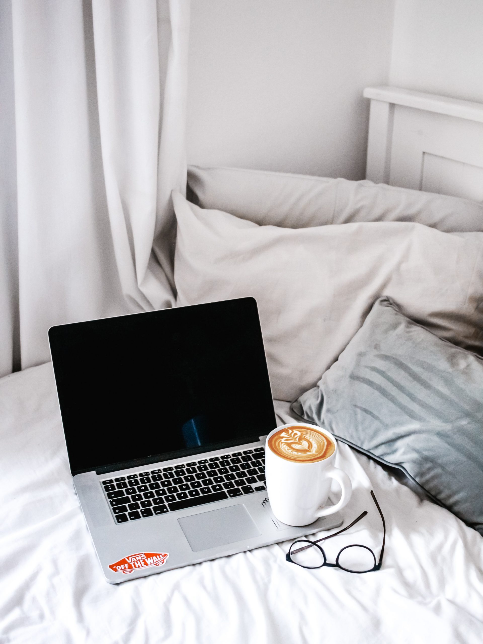 How to Work Successfully with a Blogger - shot of laptop and coffee on bed